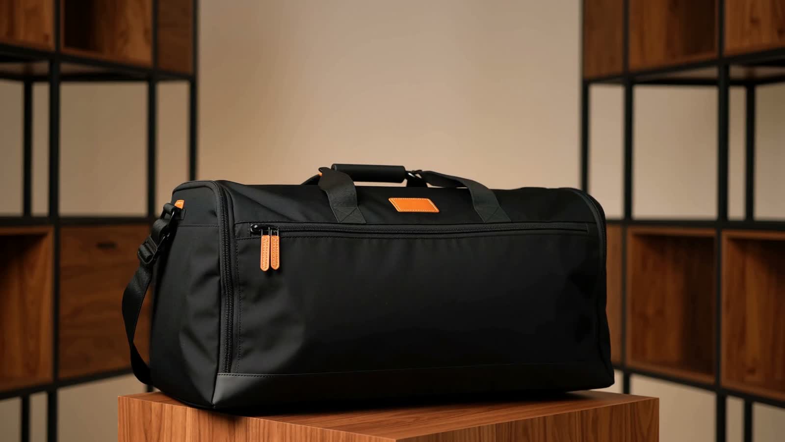 The Long Weekend black travel duffel with warm leather accents